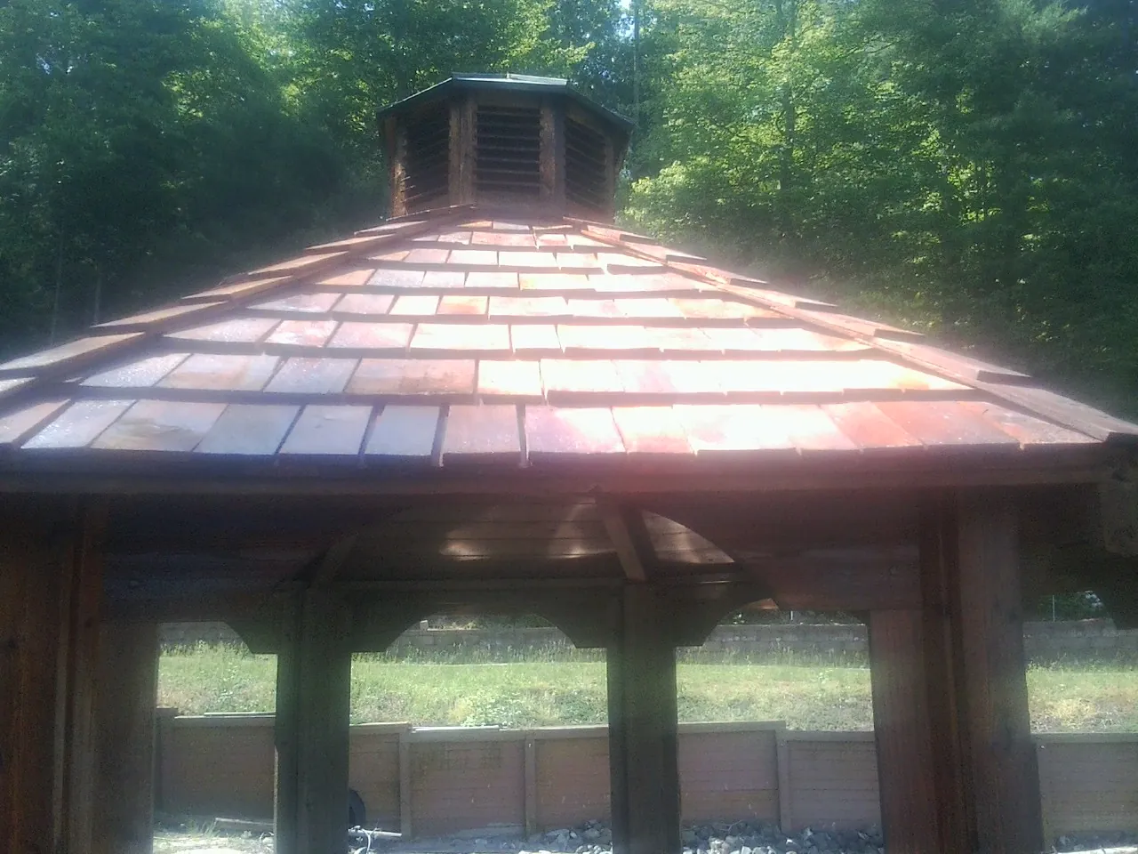New cedar shake roof and cupola on a lakeside gazebo in Stowell